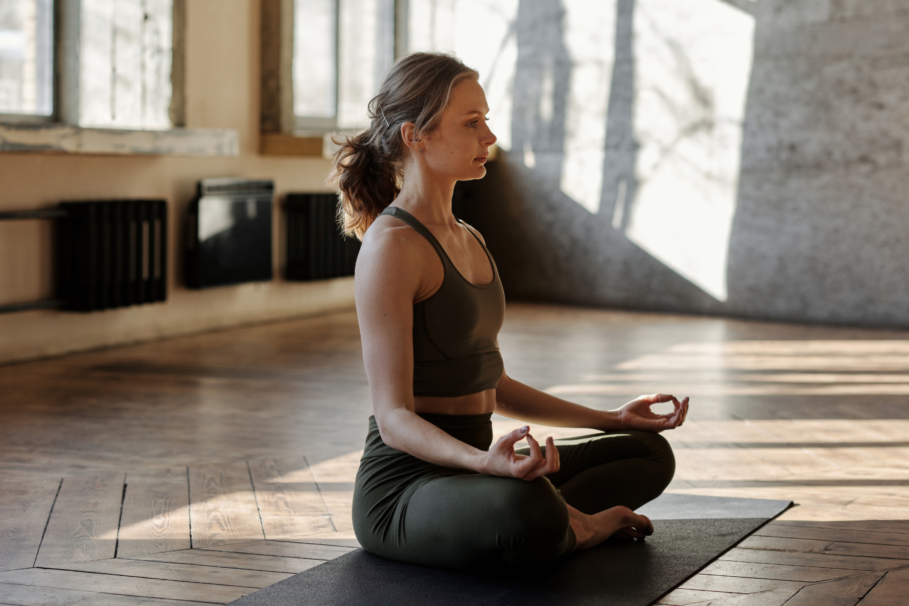a woman practicing meditation to reduce her stress
