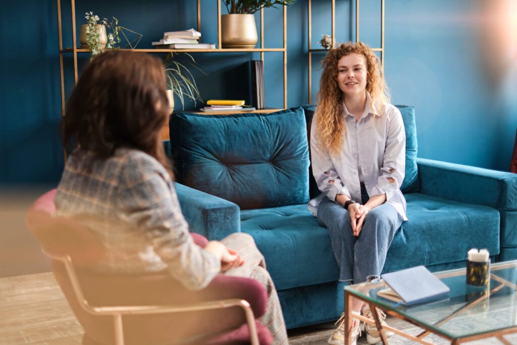woman sitting with her therapist smiling