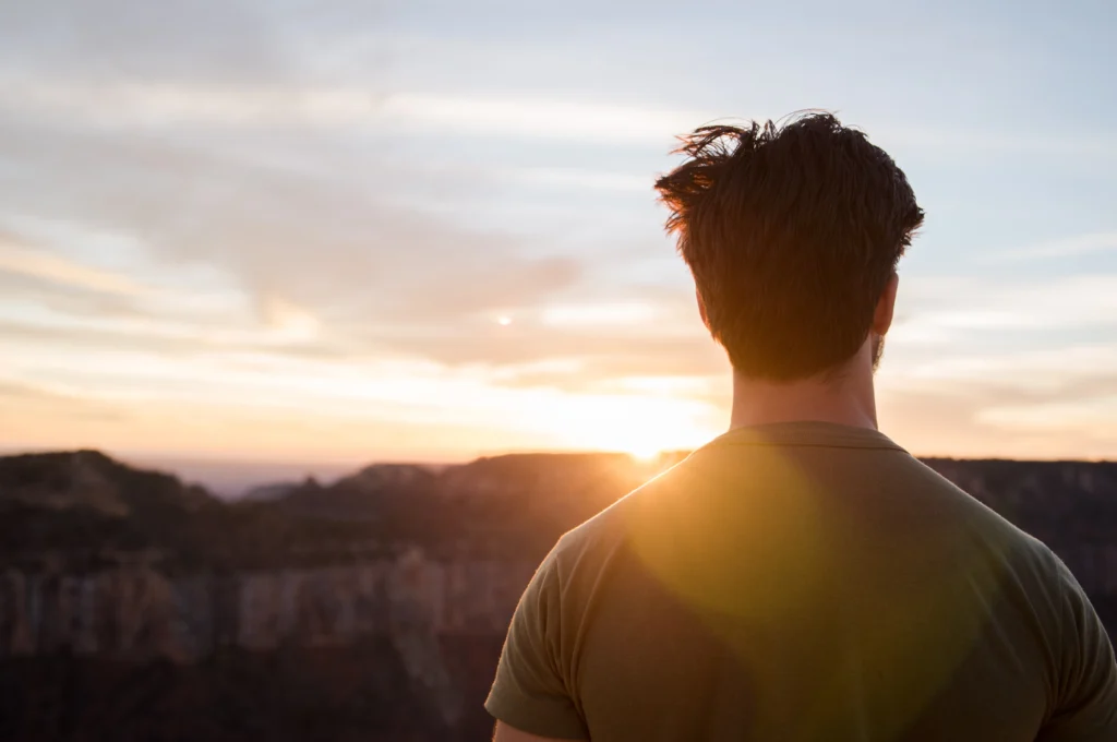 man looking out over the sunset arizona