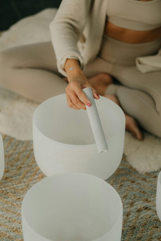 woman using crystal sound bowls for healing