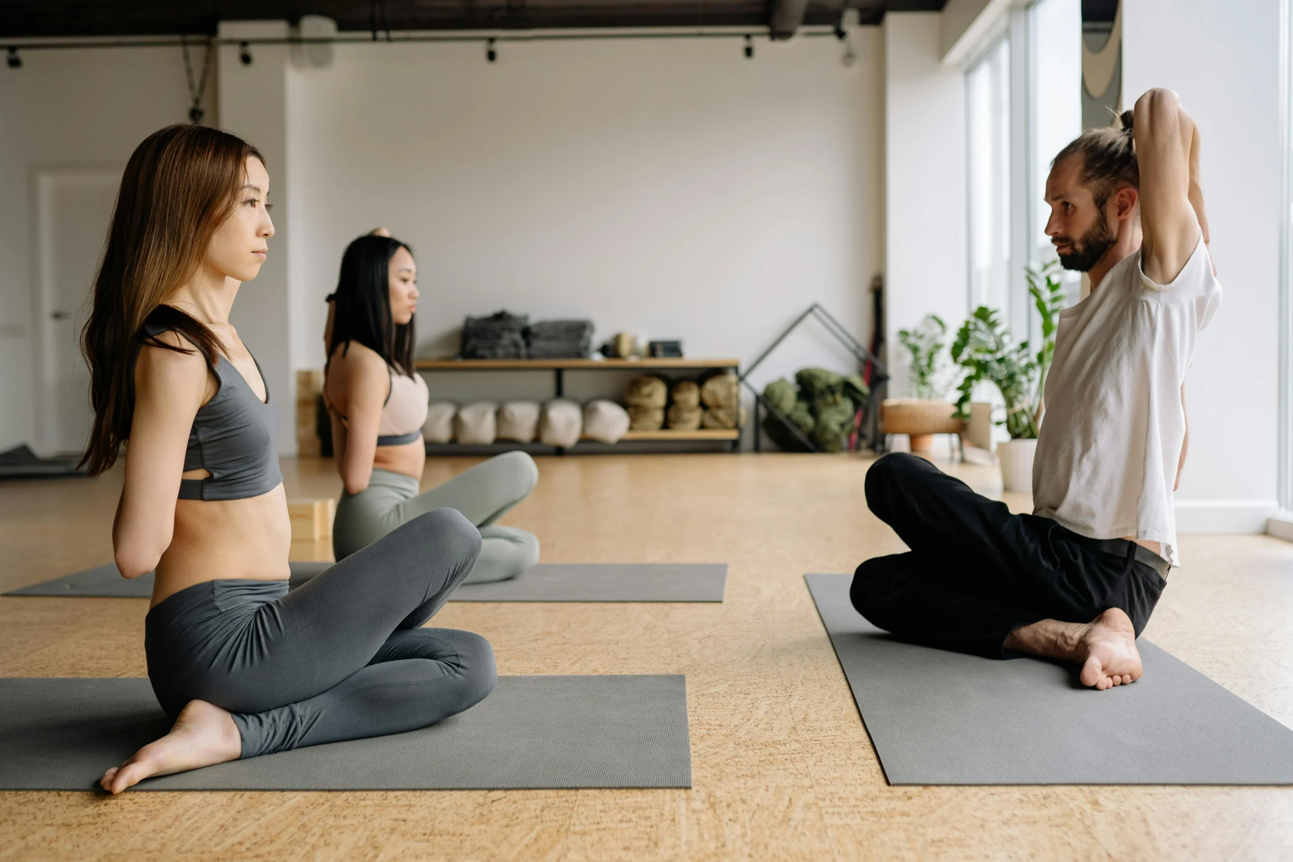 two women practicing mindfulness with male instructor