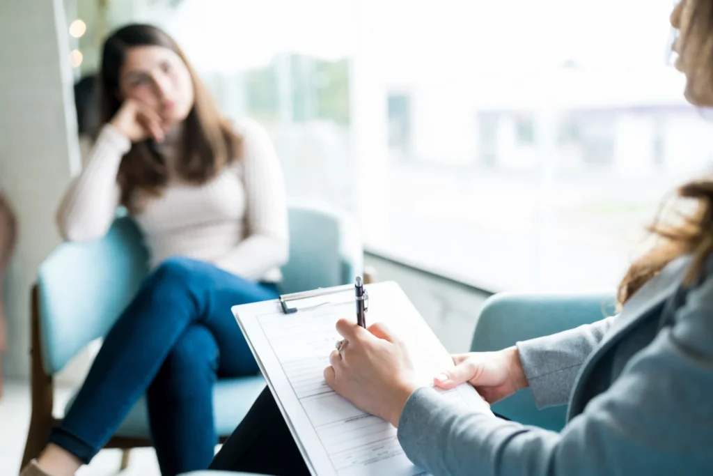 woman in therapy office with a clinical therapist