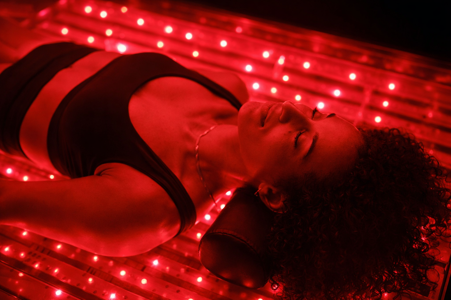 Adult receiving a red light therapy session, one of the adjunct modalities offered alongside clinical care