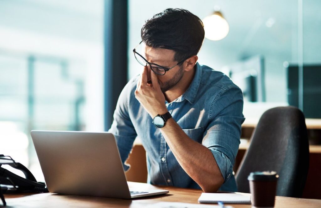 man-experiencing-work-stress-fatigue-at-desk