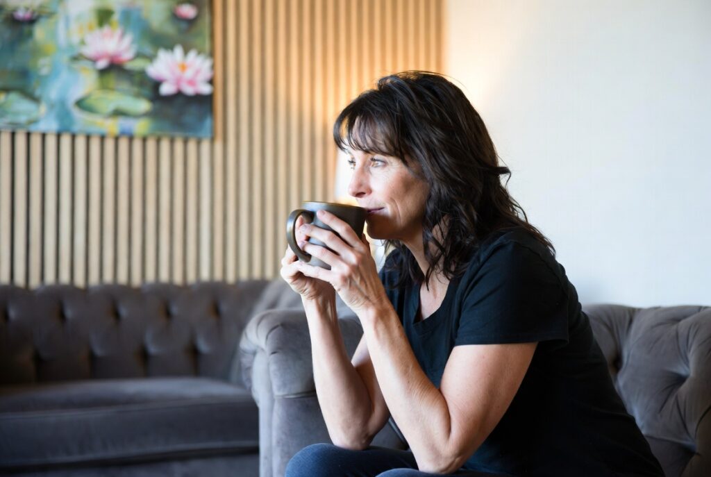 a woman lounging at redefine drinking a coffee