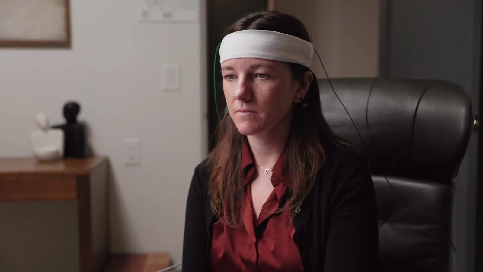 Close-up of EEG sensor placement on a client's scalp before a neurofeedback training session