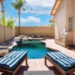 Backyard pool with lounge chairs at Cholla, a residential location for men
