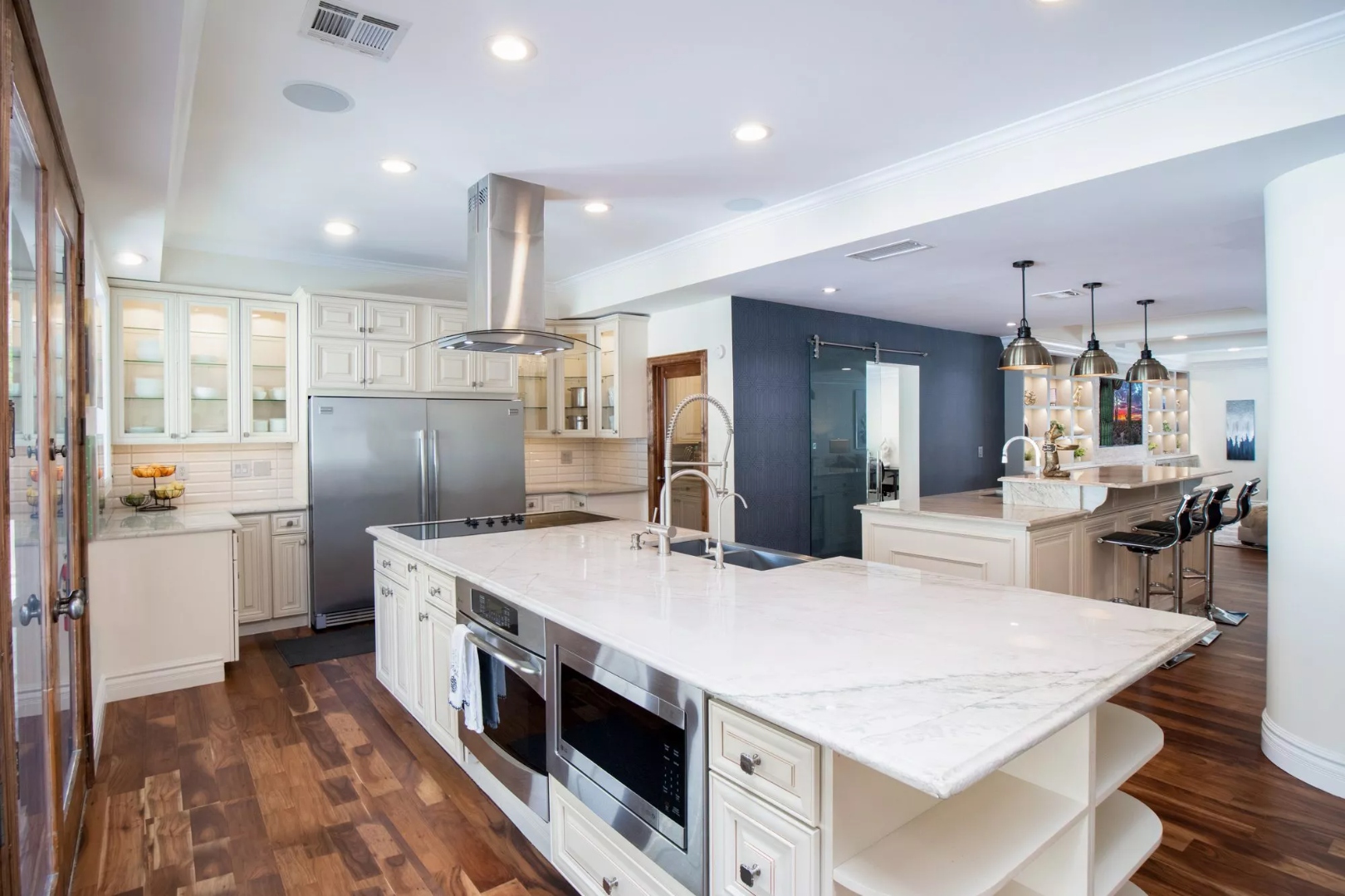 A white kitchen with a large island at Mariposa, a residential location for women