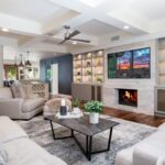 Living room with a fireplace and built-in shelving at Mariposa, a residential location for women